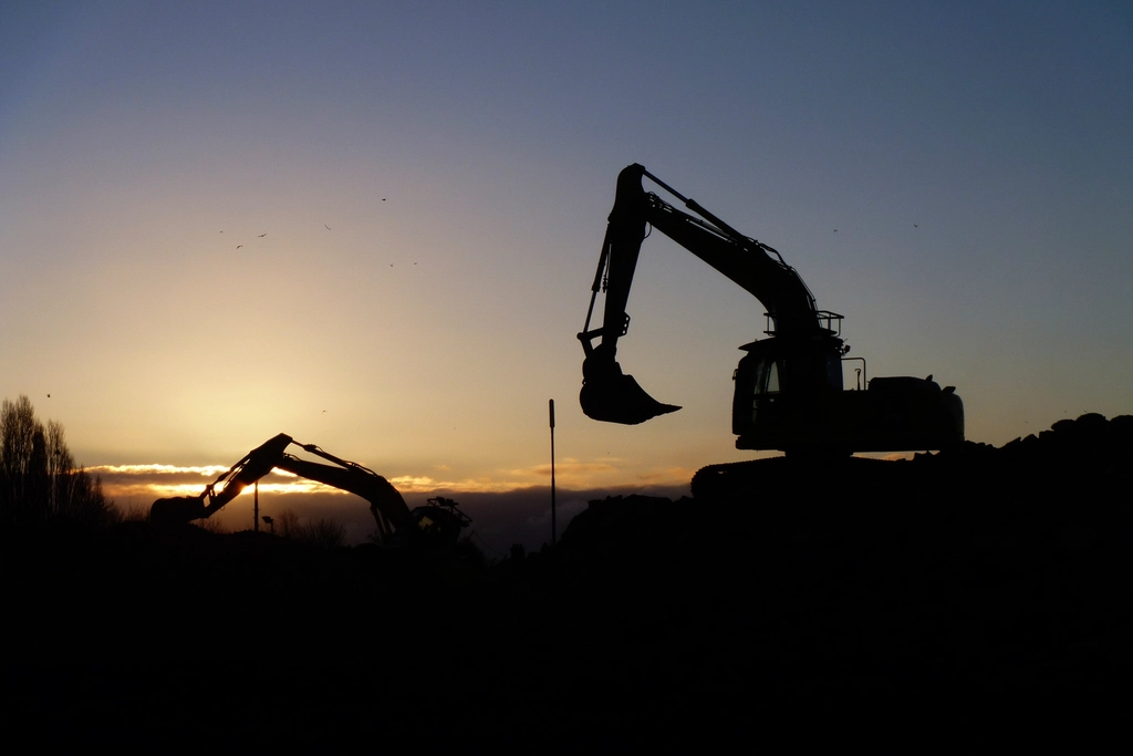 Excavator working at sunset